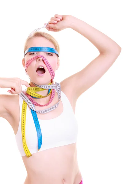 Obsessed fitness woman with a lot of colorful measure tapes — Stock Photo, Image