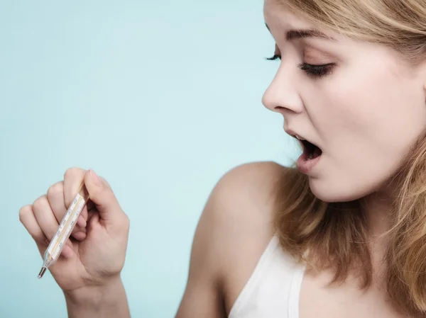 Sick girl checking thermometer — Stock Photo, Image