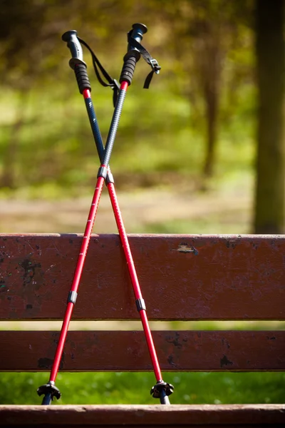 Nordic walking equipment on bench. — Stock Photo, Image