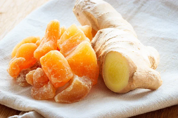 Root and candied ginger on table — Stock Photo, Image