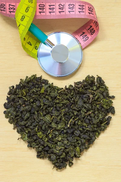 Green tea leaves and stethoscope — Stock Photo, Image