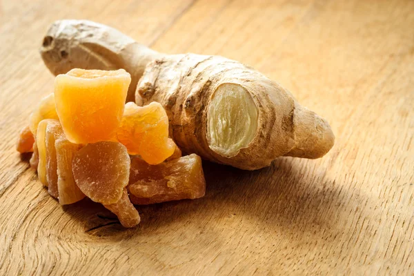 Root and candied ginger on table — Stock Photo, Image