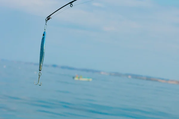 Rod with wobbler and sea — Stock Photo, Image