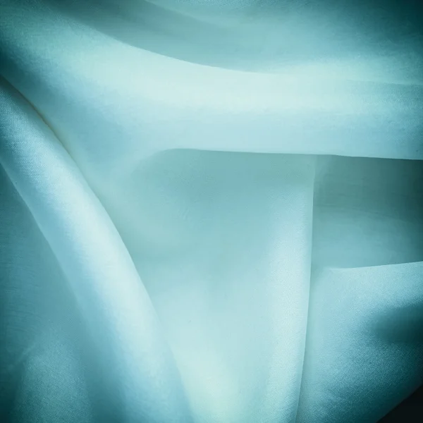 Folds of blue silk textile — Stock Photo, Image