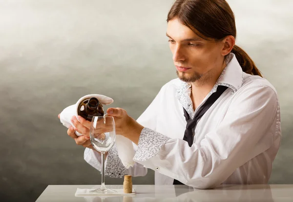 Man waiter pouring wine into glass — Stock Photo, Image