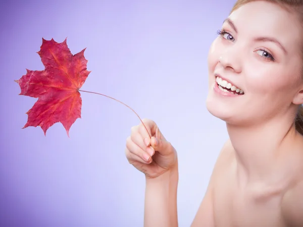 Woman with red maple leaf — Stock Photo, Image