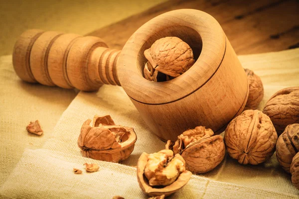 Walnut with nutcracker on table — Stock Photo, Image