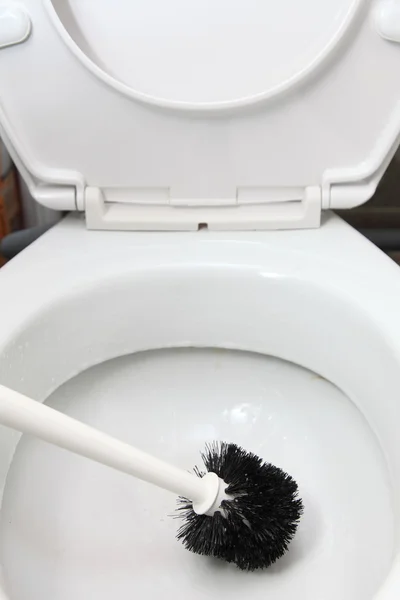 Cleaning toilet bowl with brush — Stock Photo, Image