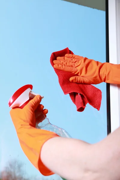 Gloved hand cleaning window — Stock Photo, Image