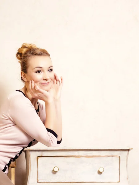 Girl sitting on wooden chair — Stock Photo, Image