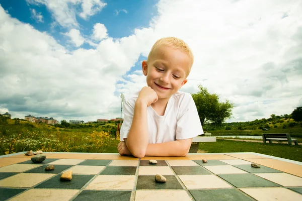 Child playing draughts or checkers — Stock Photo, Image