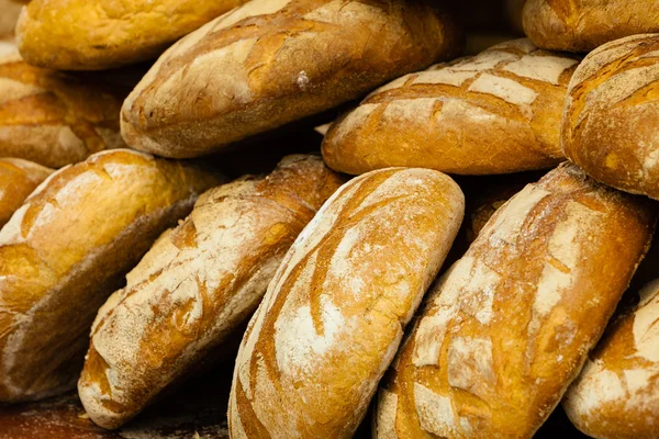 Many rustic fresh bread loaves — Stock Photo, Image