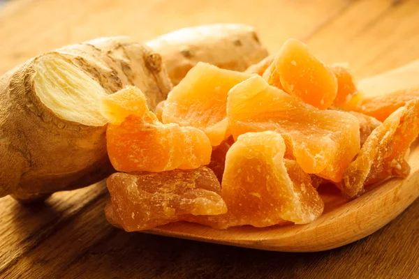 Root and candied ginger on table — Stock Photo, Image