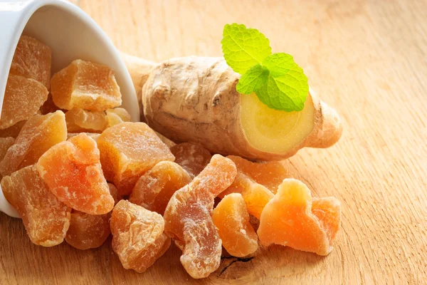 Root and candied ginger on table — Stock Photo, Image