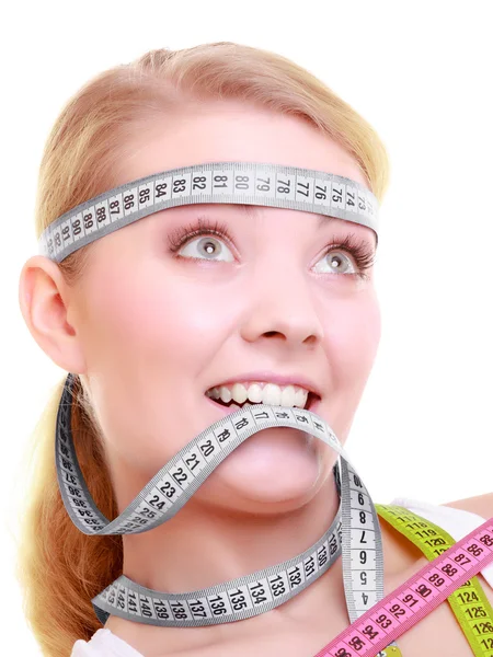 Woman with measure tapes around head — Stock Photo, Image