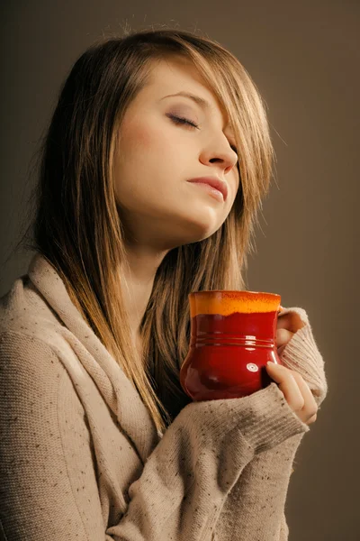 Girl holding cup of tea