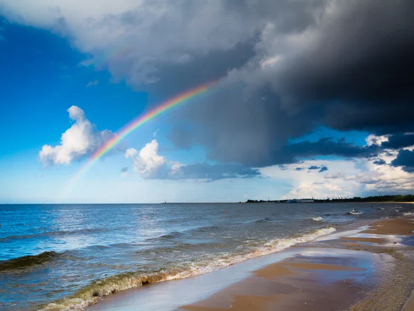 Sky with rainbow at sea — Stock Photo, Image