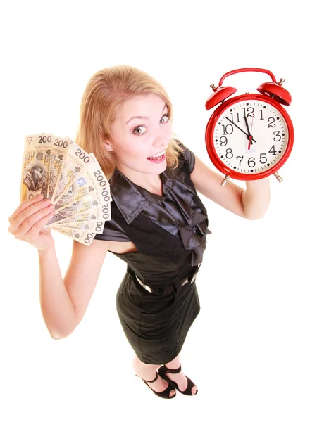 Woman holding money and alarm clock — Stock Photo, Image