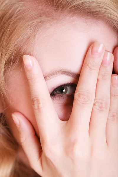 Woman peeking through her fingers — Stock Photo, Image