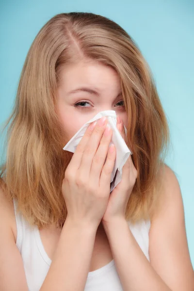 Sick woman sneezing in tissue — Stock Photo, Image