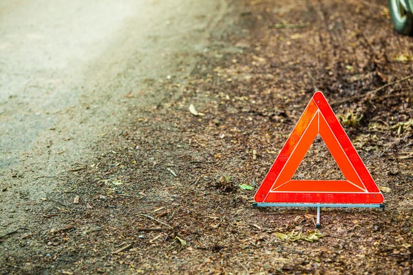 Red warning triangle sign on road — Stock Photo, Image