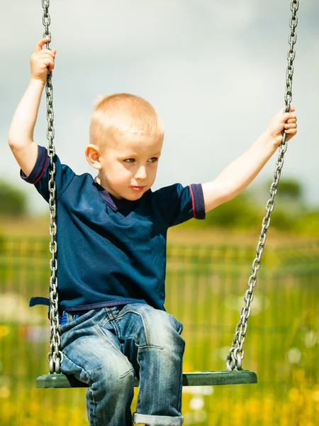 Boy having fun on swing — Stock Photo, Image