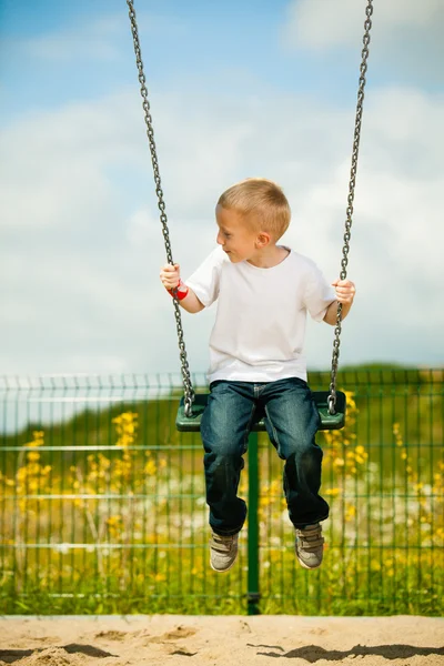 Boy having fun on swing — Stock Photo, Image