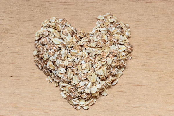 Oat flakes cereal heart shaped — Stock Photo, Image