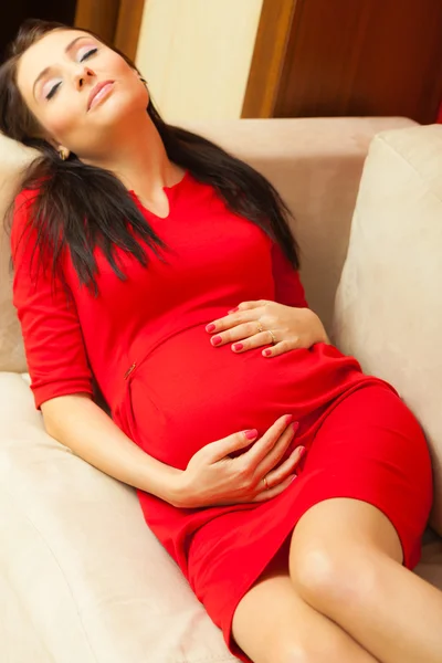 Femme enceinte relaxant sur canapé — Photo