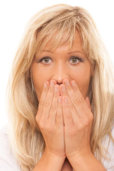 Woman covering mouth with hands — Stock Photo, Image