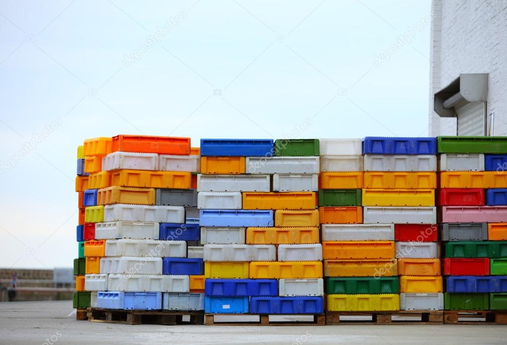 Colorful boxes plastic crates containers for fish — Stock Photo