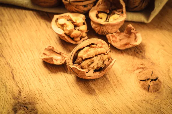 Walnuts on rustic old wooden table — Stock Photo, Image