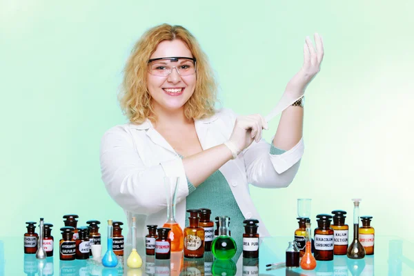 Chemist woman  putting on gloves — Stock Photo, Image