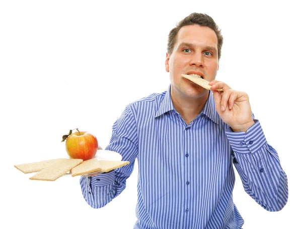 Man eating crispbread and apple Royalty Free Stock Photos