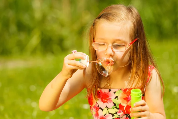 Little girl  blowing soap bubbles — Stock Photo, Image