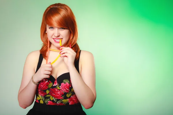 Redhair girl holding sweet food jelly candy on green. — Stock Photo, Image