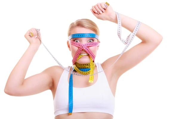 Woman with many colorful measure tapes — Stock Photo, Image