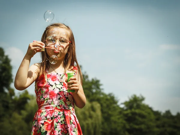 Little girl  blowing soap bubbles — Stock Photo, Image