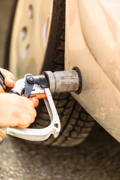 Car at gas station being filled with fuel — Stock Photo, Image