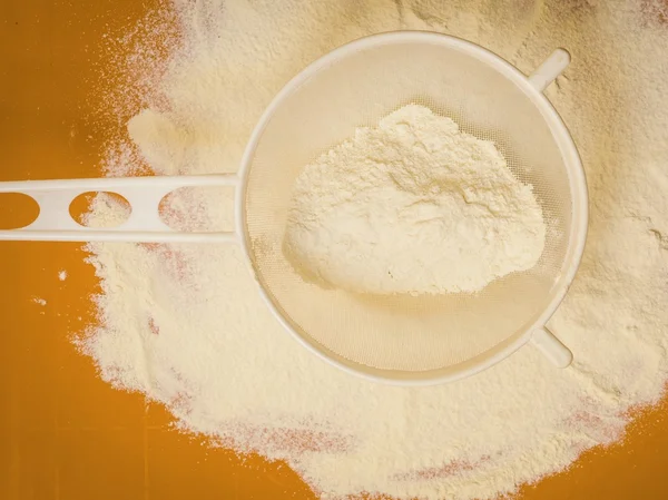 Sifting wheat flour — Stock Photo, Image