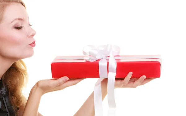 Girl with red gift box blowing kiss — Stock Photo, Image