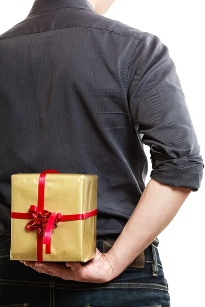 Man hiding gift box behind back Royalty Free Stock Photos