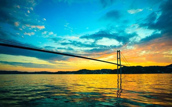 Sunset over suspension bridge — Stock Photo, Image