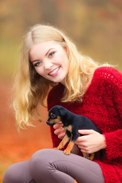 Woman embrancing her puppy dog Stock Image