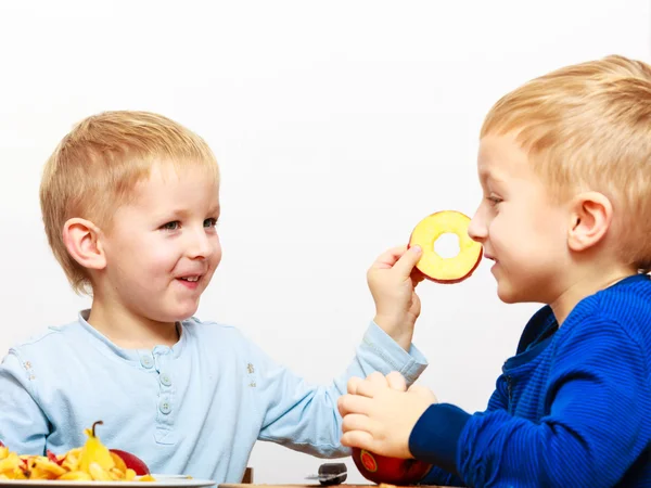 Little boys peeling apple — Stock Photo, Image
