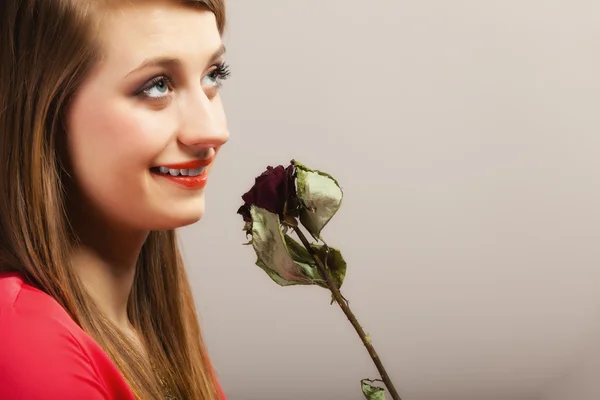 Girl in red gown holding rose. — Stock Photo, Image