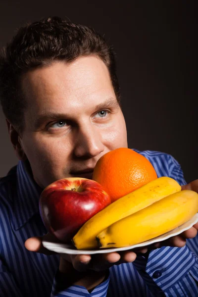 Hombre oliendo frutas . — Foto de Stock