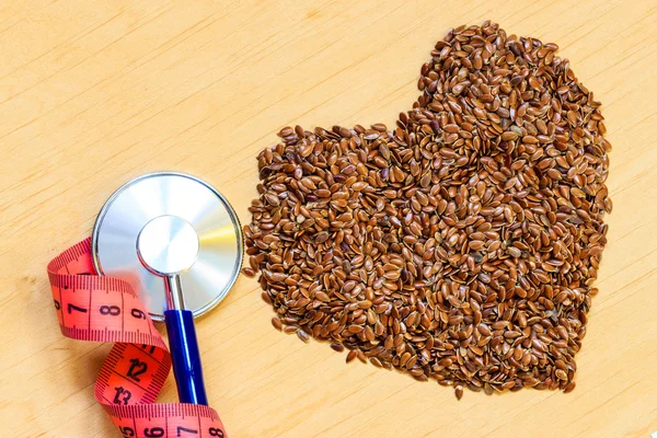 Flax seeds and stethoscope — Stock Photo, Image