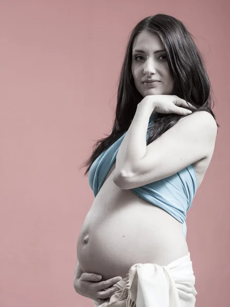 Attractive pregnant woman touching her belly — Stock Photo, Image