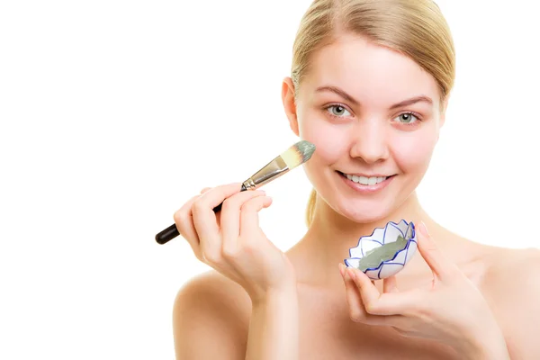 Skin care. Woman applying clay mud mask on face. — Stock Photo, Image